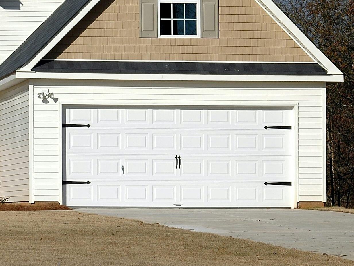 Elegant two-storey house with garage, showcasing modern architecture and residential charm.